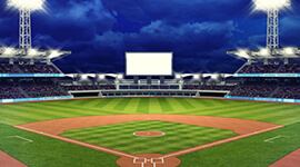 View looking at a baseball field with the lights on